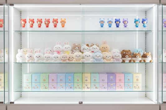 Colorful prize display cabinet with blind boxes, plush toys, and collectible figures – best prizes for claw machine revenue optimization